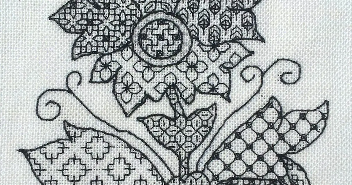 Blackwork embroidery with black geometric fill patterns stitched on white evenweave fabric
