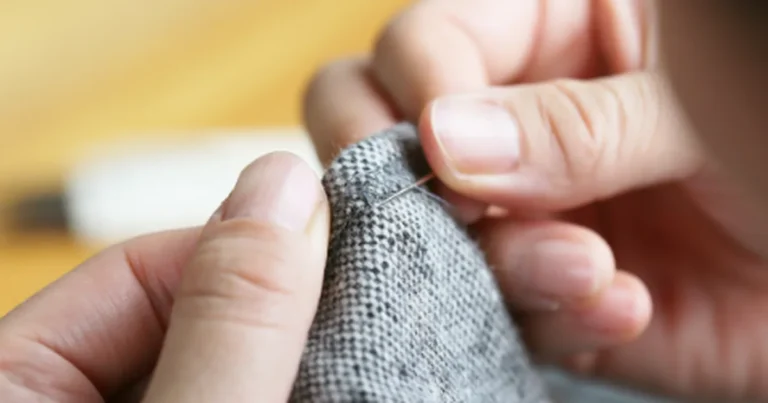 Hands repairing clothes, showing how handmade garments last for years