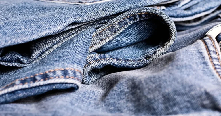 Close-up of blue denim jeans showing the twill weave and stitching