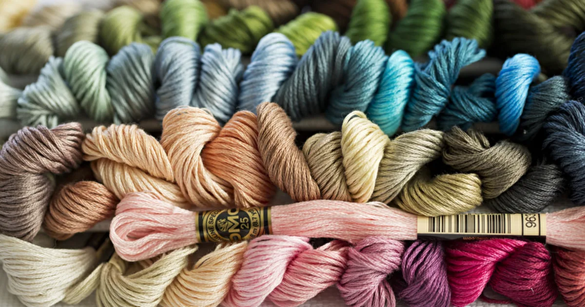 Colourful skeins of embroidery thread arranged together