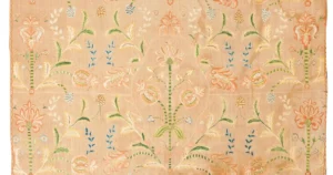 Antique embroidered textile carefully preserved and displayed