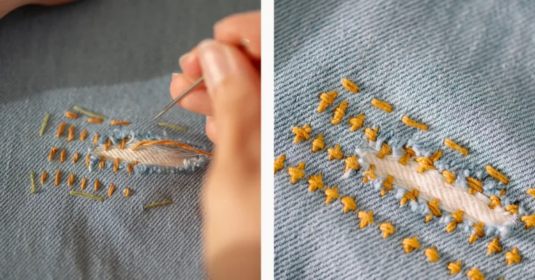 Sashiko visible mending on denim jeans with golden running stitches reinforcing a patched tear