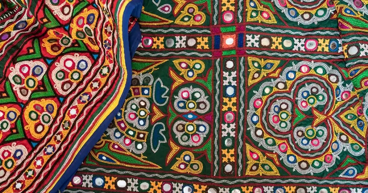 Colorful Kutchi mirror-work textile with shisha mirrors set in dense geometric embroidery frames